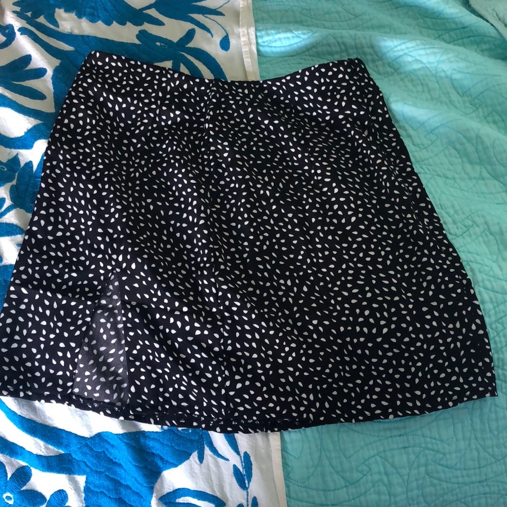 Black mini skirt with slit.